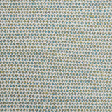 A handwoven rug with a herringbone weave in white with striated yarns of green and turquoise.