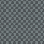 Detail of printed wallpaper in a watercolor ikat-inspired checkerboard pattern in tonal shades of charcoal-blue.