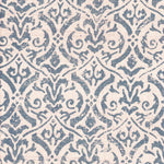 Detail of fabric in a botanical damask print in blue-gray on a cream field.