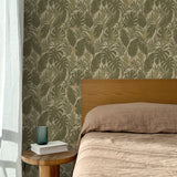 Bed with tan linens and wooden headboard, wooden side table  with white book and green glass, white floor length curtain against a olive green and tan tropical wallpaper. 