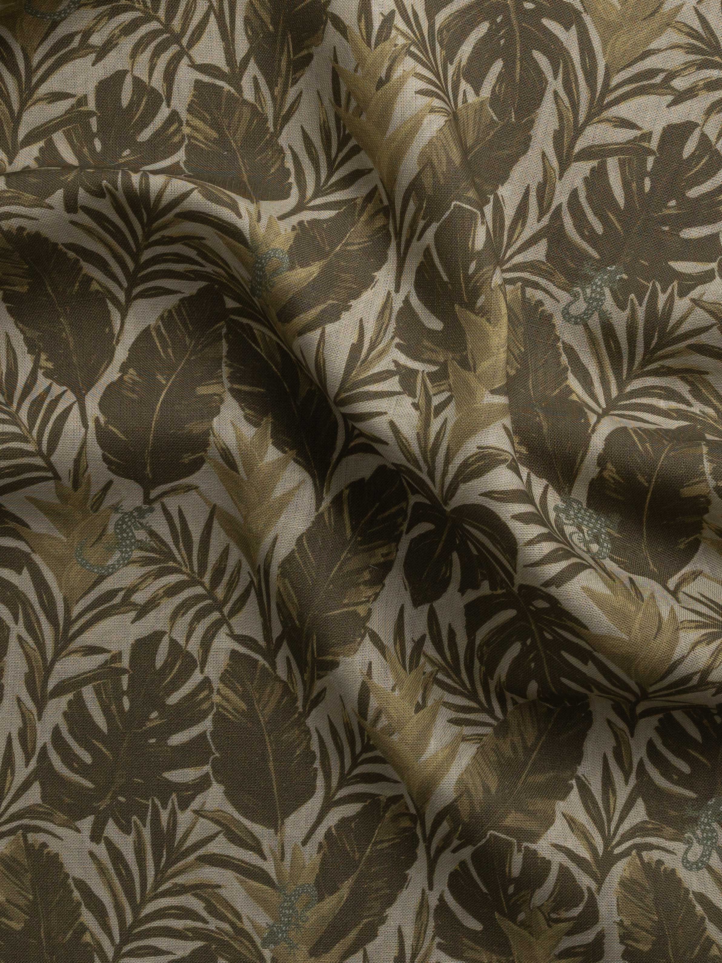 Detail of gently draped printed fabric in a tropical palm frond pattern in muted brown  scattered with small grey-green lizards. 
