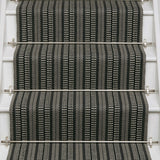Striped flatweave runner in black and white on white staircase