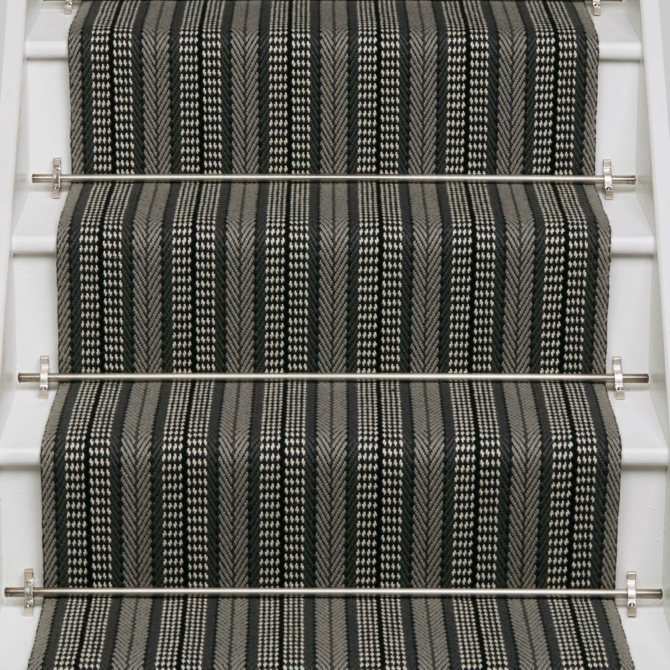 Striped flatweave runner in black and white on white staircase