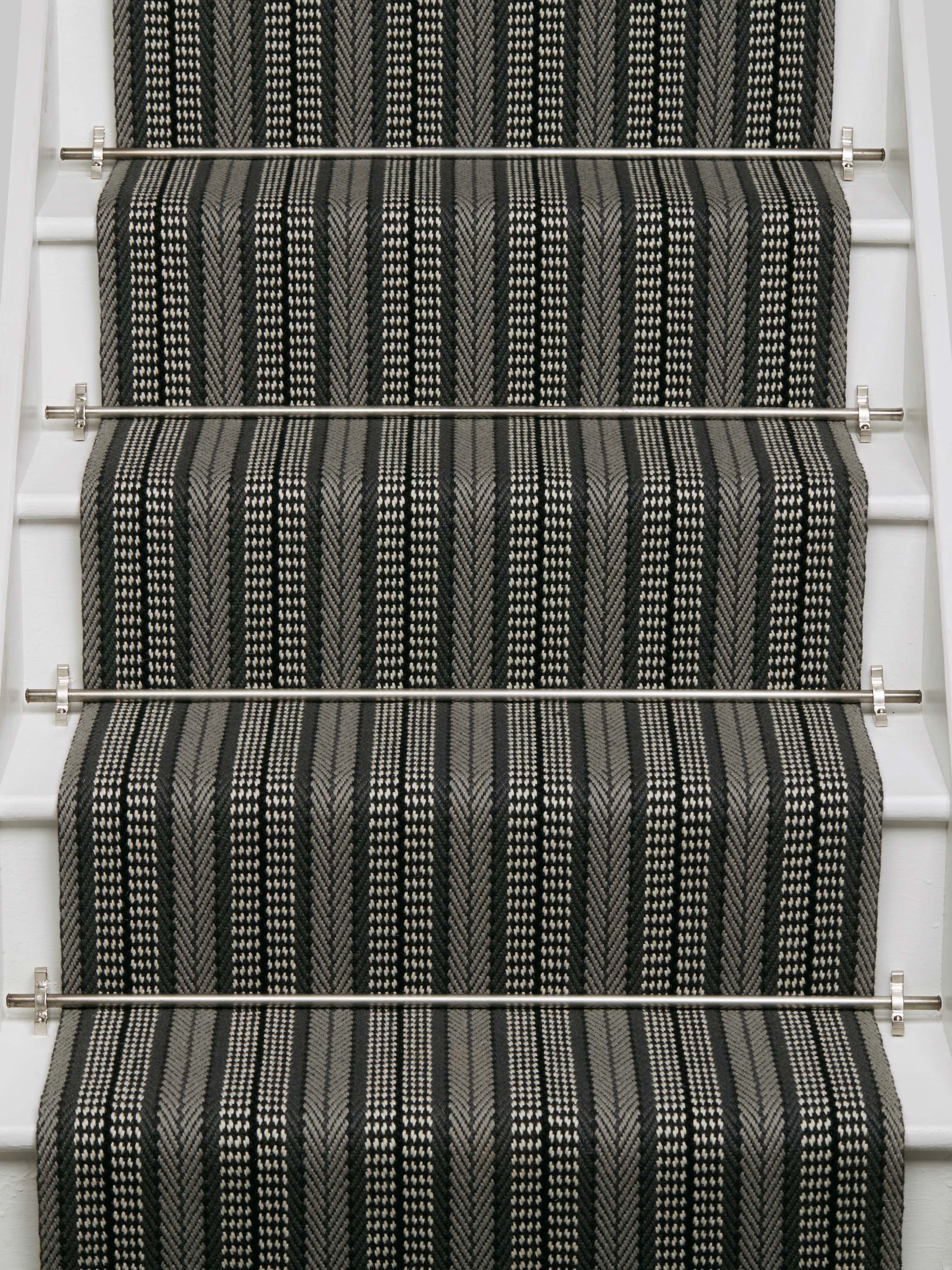 Striped flatweave runner in black and white on white staircase