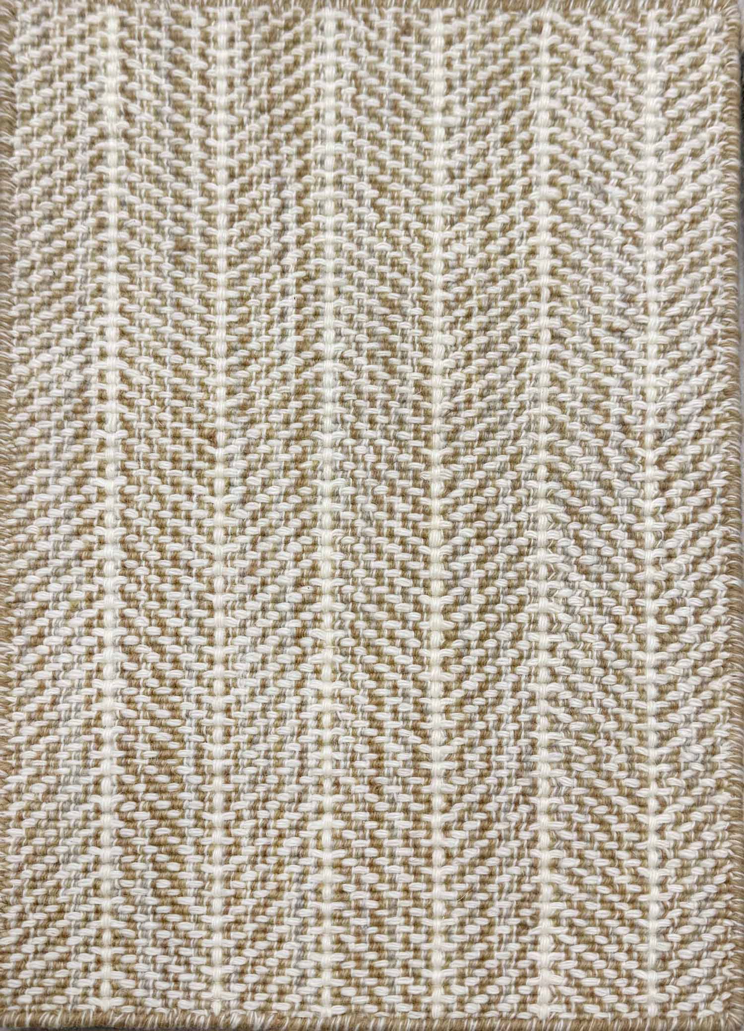 Close up of broadloom carpet with striated herringbone weave in white with accents of tan and brown.