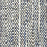 Close up of broadloom carpet with striated herringbone weave in white with accents of blue and brown.