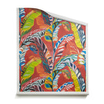 A roll of wallpaper with expressive painterly banana-leaf pattern in red, yellow, green, pink and blue on a red field. 