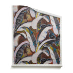 A roll of wallpaper with linear painterly banana-leaf pattern in lilac, white, yellow, black and blue on a rust red and brown background. 