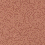 Fabric with an abstract embroidered pattern in clay pink on a clay pink field.