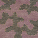 Detail of a handwoven rug in an abstract coral design grey and purple with a tan accent line. 