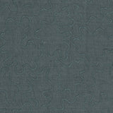 Detail of fabric with an abstract embroidered pattern in gray on a gray field.
