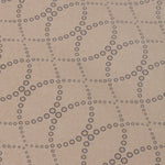 Detail of a wallpaper in a playful floral lattice print in tan and navy on a taupe field.