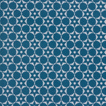 Wallpaper in a floral lattice print in cream on a indigo blue field.