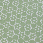 Wallpaper detail in a floral lattice print in  jade green on a cream field.