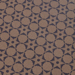Wallpaper detail in a floral lattice print in navy on a kraft brown field