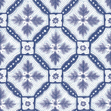 Detail of wallpaper in a painterly botanical grid in shades of navy and purple on a white field.
