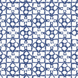 Detail of wallpaper in a botanical lattice print in navy on a white field.