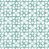 Detail of wallpaper in a botanical lattice print in teal on a white field.