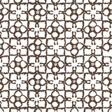 Detail of wallpaper in a botanical lattice print in brown on a white field.