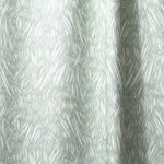 Draped linen in  an abstract leaf pattern in white on a pale aqua watercolor field.