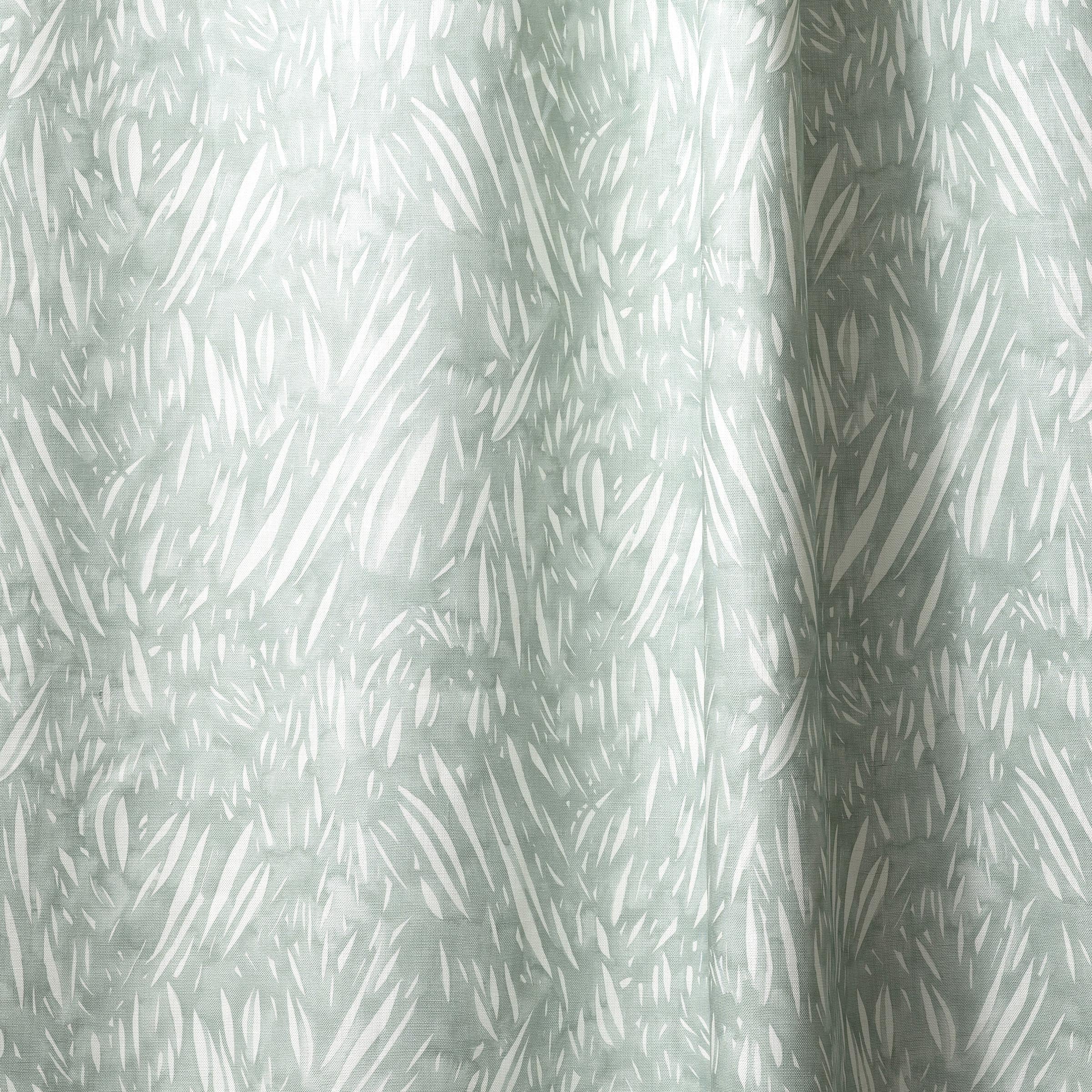 Draped linen in  an abstract leaf pattern in white on a pale aqua watercolor field.