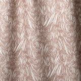 Draped linen in  an abstract leaf pattern in white on a warm brown watercolor field.