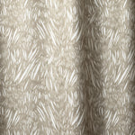 Draped linen in  an abstract leaf pattern in white on a taupe grey watercolor field.