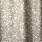 Draped linen in  an abstract leaf pattern in white on a taupe grey watercolor field.