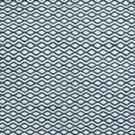 Flatweave rug in a small scale zigzag dot stripe in cream on a navy blue field.