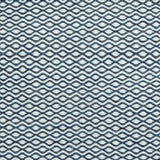 Flatweave rug in a small scale zigzag dot stripe in cream on a navy blue field.