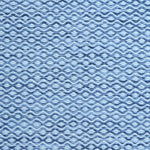 Flatweave rug in a small scale zigzag dot stripe in cream on a heather blue field.