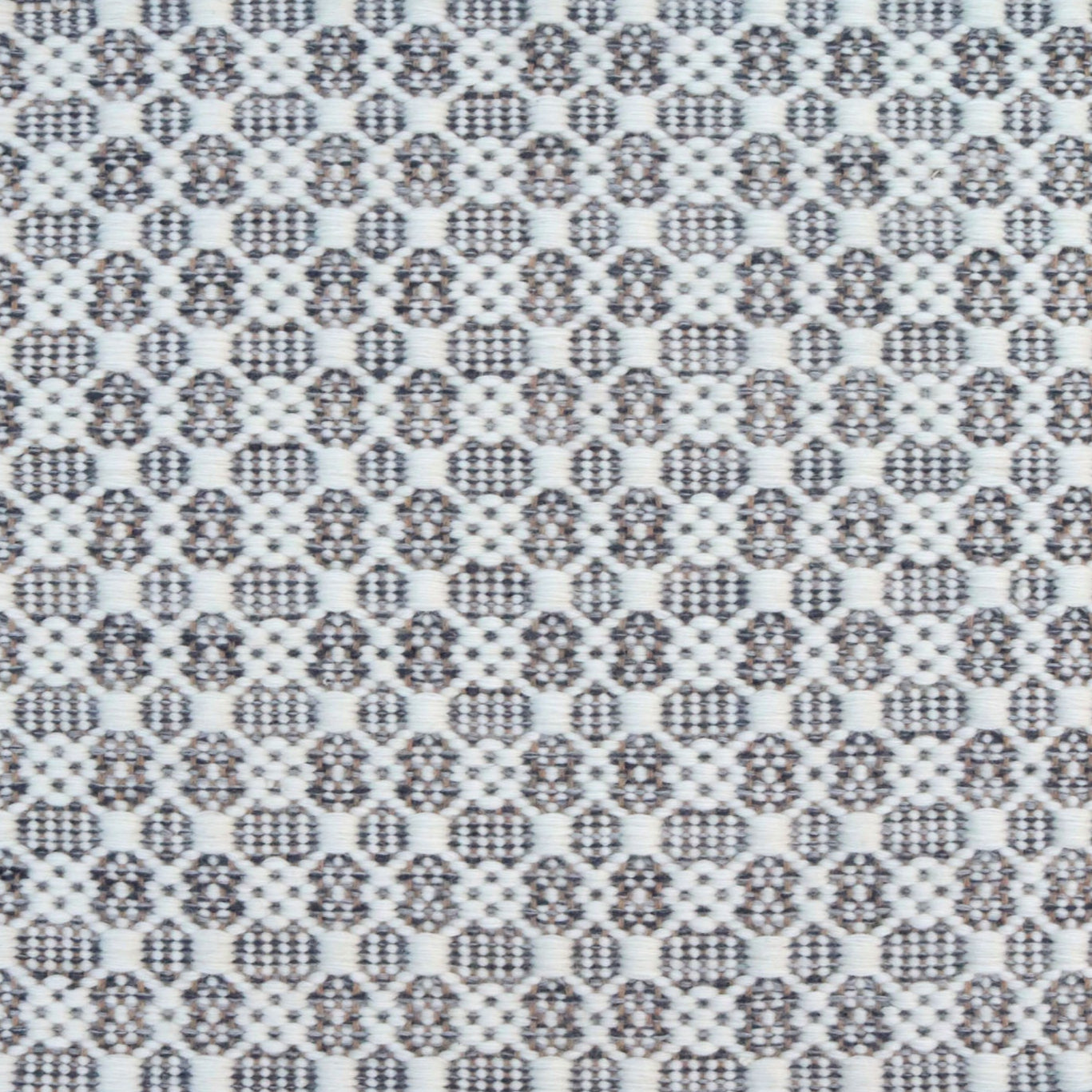 Flatweave rug in a small scale decorative lattice design in cream on a slate grey field