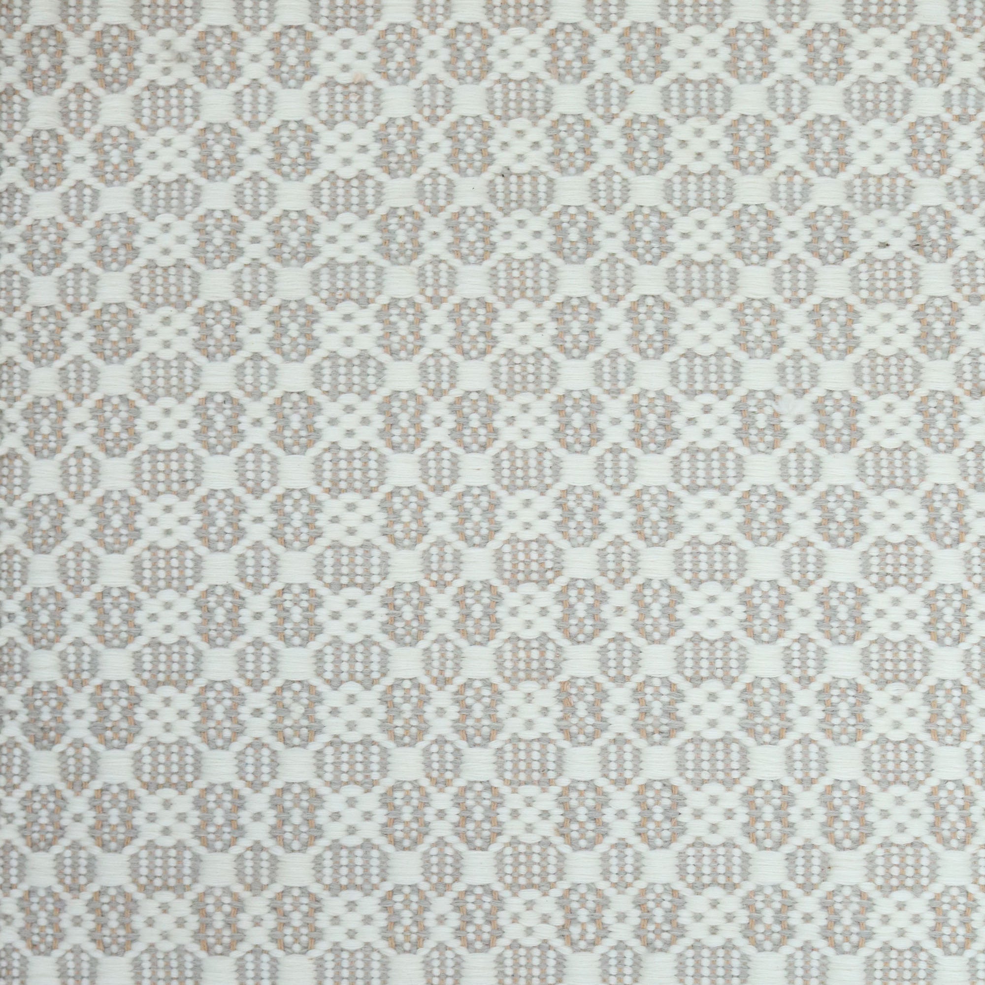Flatweave rug in a small scale decorative lattice design in cream on a grey and tan field. 