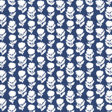 Detail of fabric in a classic floral silhouette print in cream on a cobalt field