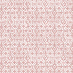 Detail of fabric in a gridded damask print in white on a light pink field.