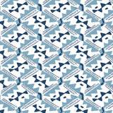 Detail of wallpaper in painterly diamond print in blue and navy on a white field.
