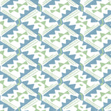 Detail of wallpaper in painterly diamond print in blue and green on a white field.