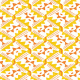 Detail of wallpaper in painterly diamond print in yellow and orange on a white field.