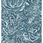 Detail of wallpaper in a painterly botanical print in white and blue on a navy field.