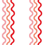Detail of fabric in a wavy stripe print in pink, red and orange on a white field.