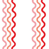 Detail of fabric in a wavy stripe print in pink, red and orange on a white field.
