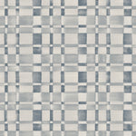 Wallpaper in a large-scale checked pattern in shades of steel blue and pale grey.