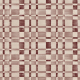 Detail of fabric in a large-scale checked pattern in shades of wine purple and beige. 