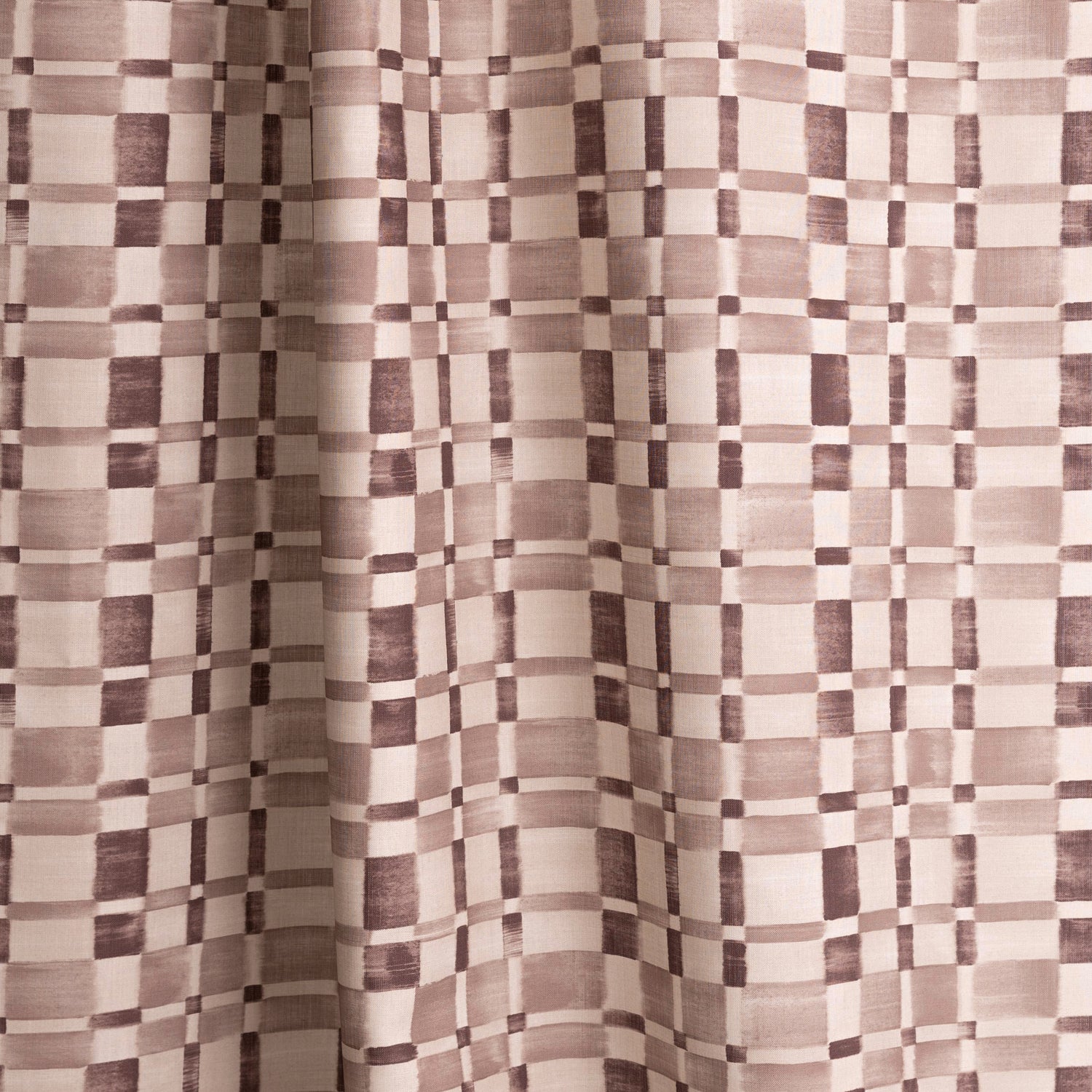 Gently draped fabric in a large-scale checked pattern in shades of wine purple and beige. 