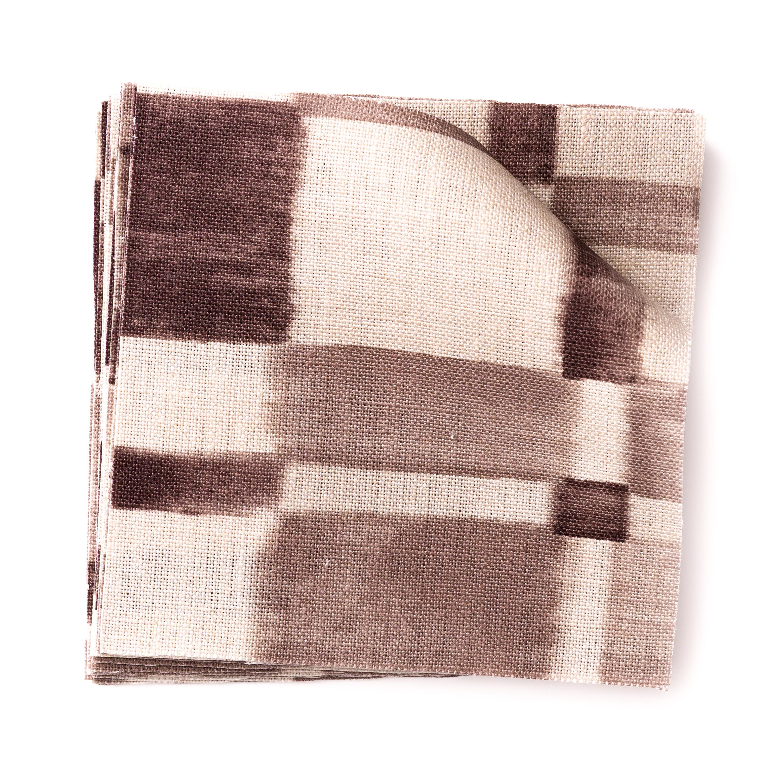 Stacked swatches of fabric in a large-scale checked pattern in shades of wine purple and beige. 