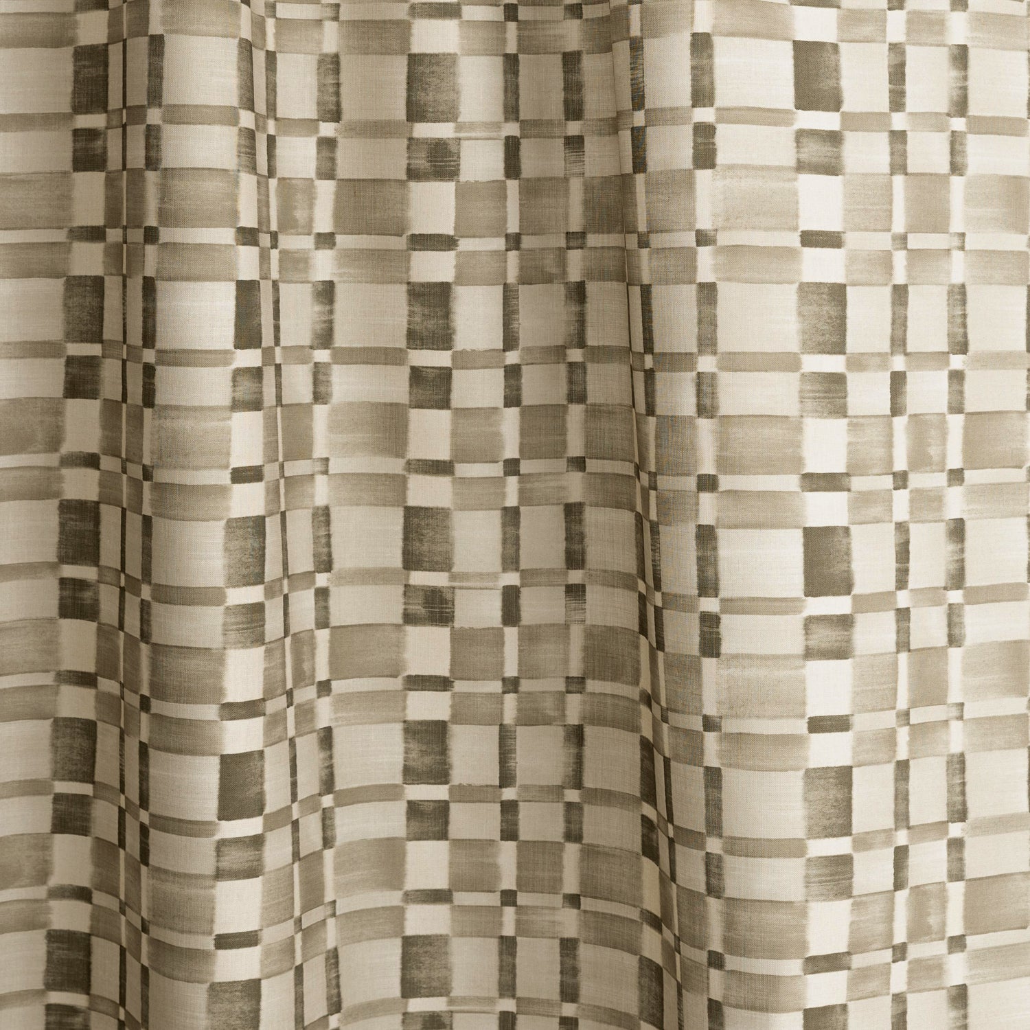 Gently draped fabric in a large-scale checked pattern in shades of olive green and cream. 