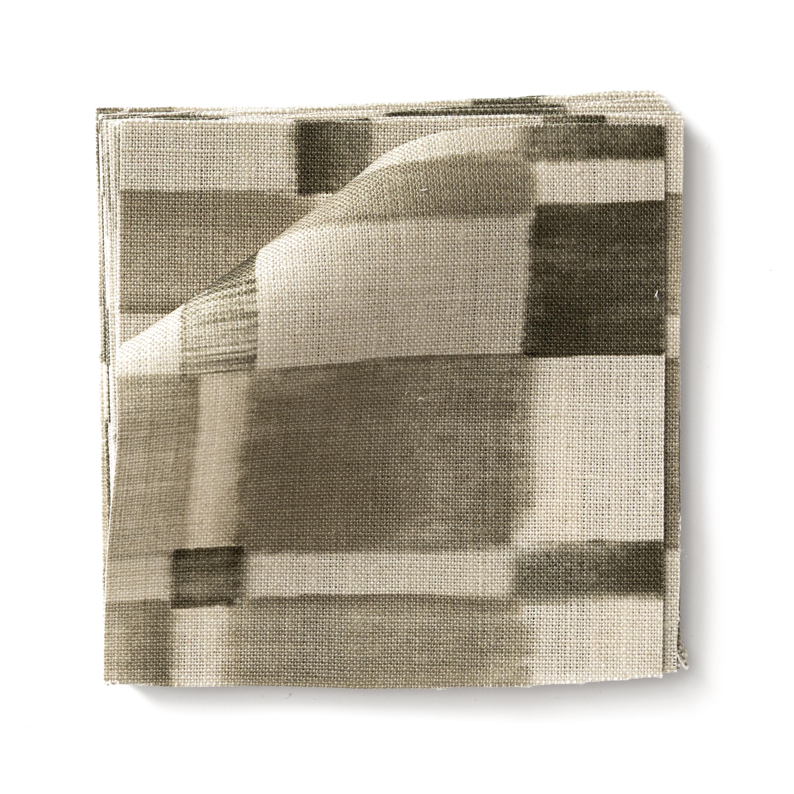 Stacked swatches of fabric in a large-scale checked pattern in shades of olive green and cream. 