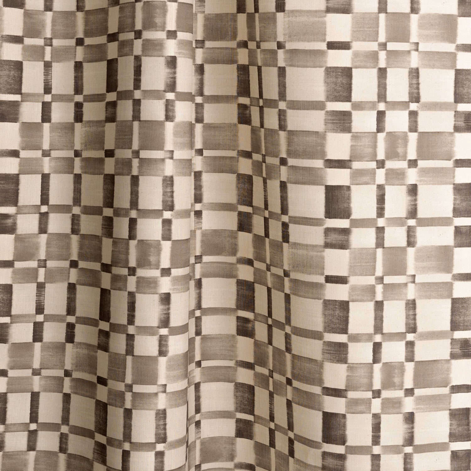 Gently draped fabric in a large-scale checked pattern in shades of charcoal grey and cream.