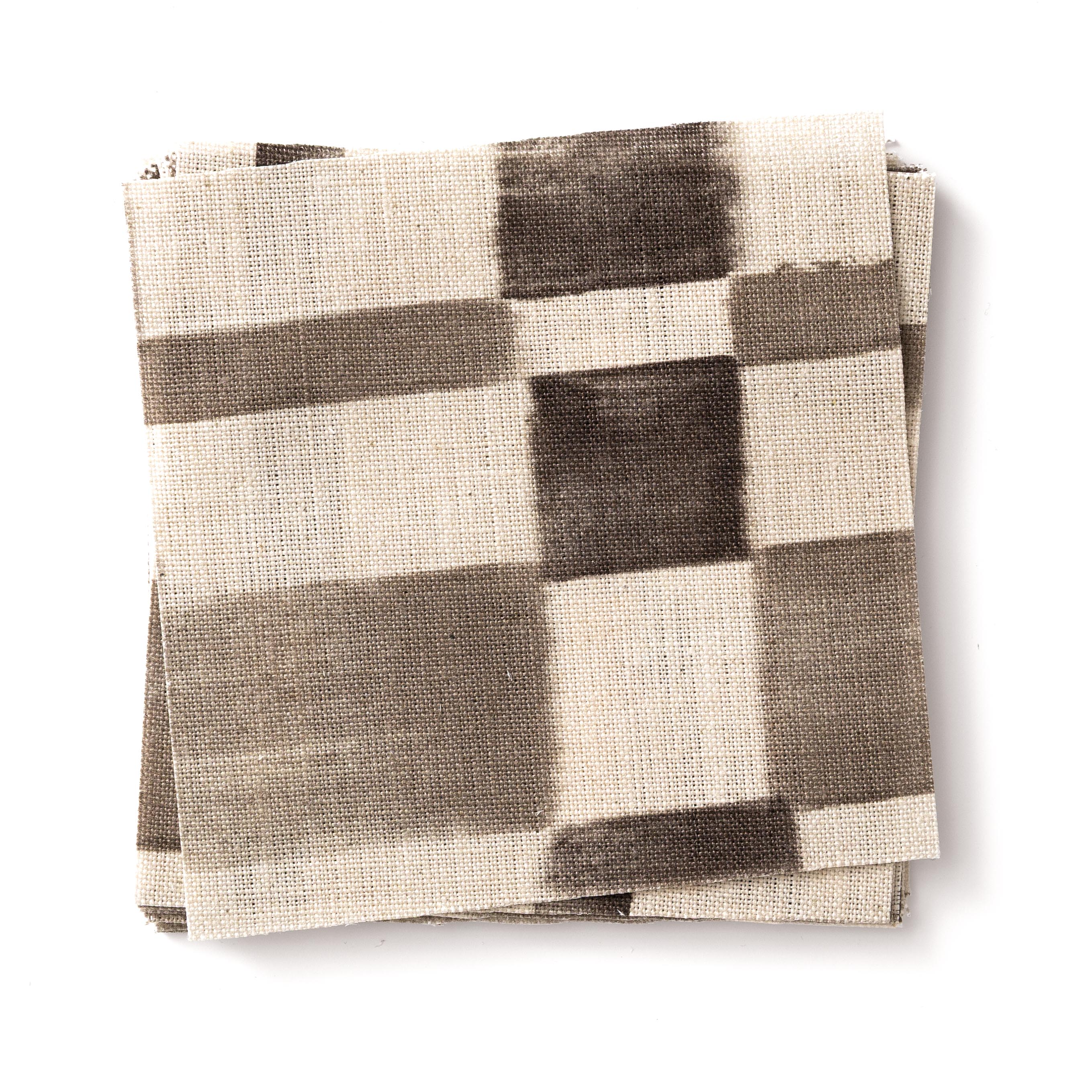 Stacked swatches of fabric in a large-scale checked pattern in shades of charcoal grey and cream.