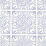 Detail of fabric in a damask lattice print in blue on a white field.